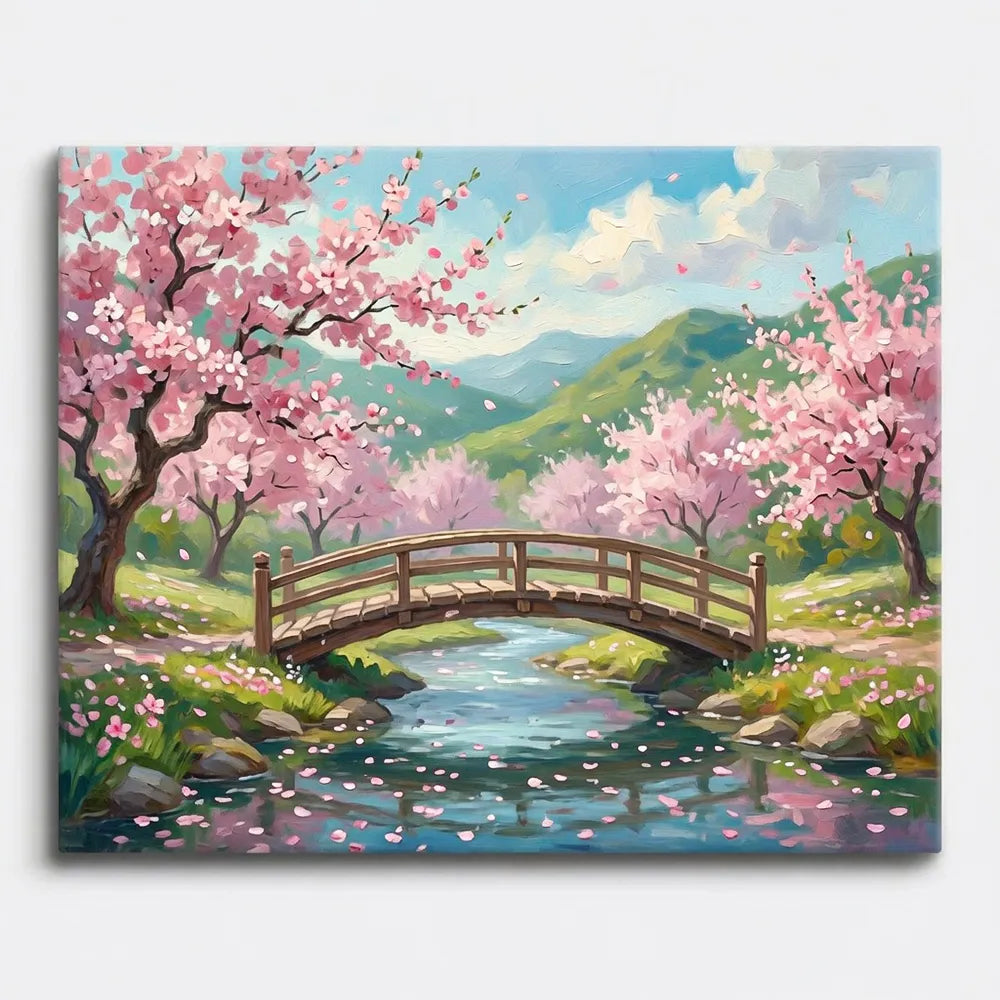 Malen nach Zahlen für Erwachsene Motiv: Frühlingslandschaft mit Holzbrücke, Bach und blühenden Kirschbäumen in Rosa.