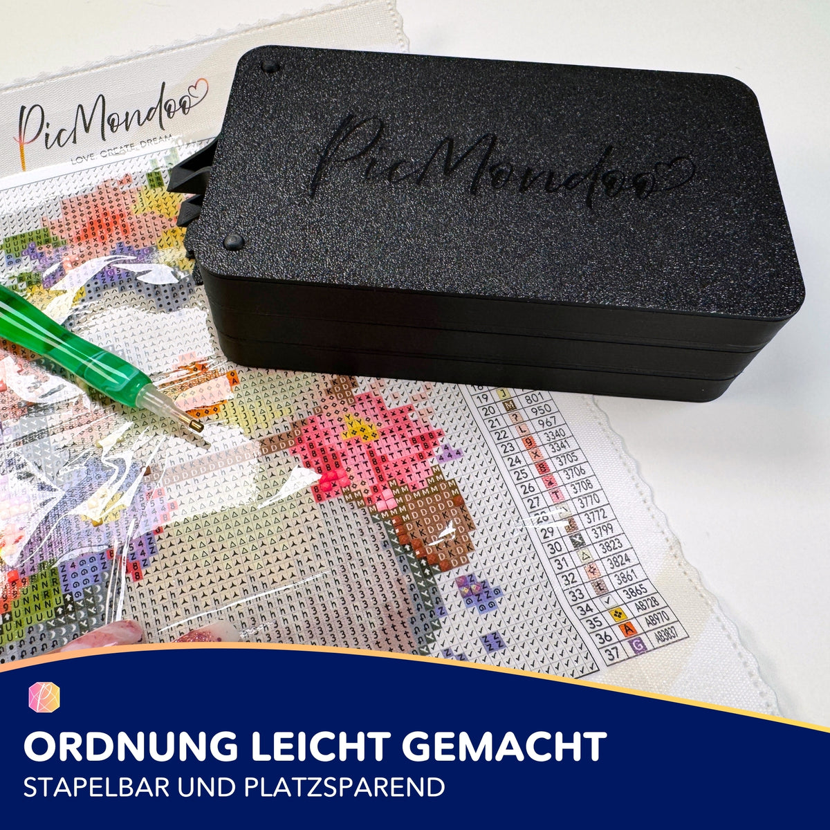 Schwarzes Picmondoo XL Schiffchen für Diamond Painting als stapelbares Zubehör mit 3D-Druck auf einer Leinwand platziert.