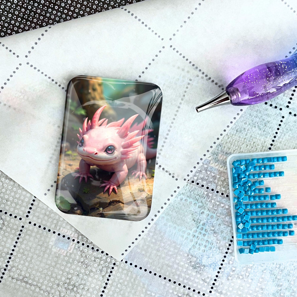 Cover Minder Axolotl aus Glas als magnetisches Zubehör für Diamond Painting auf einer Leinwand mit Stift und Steinchen