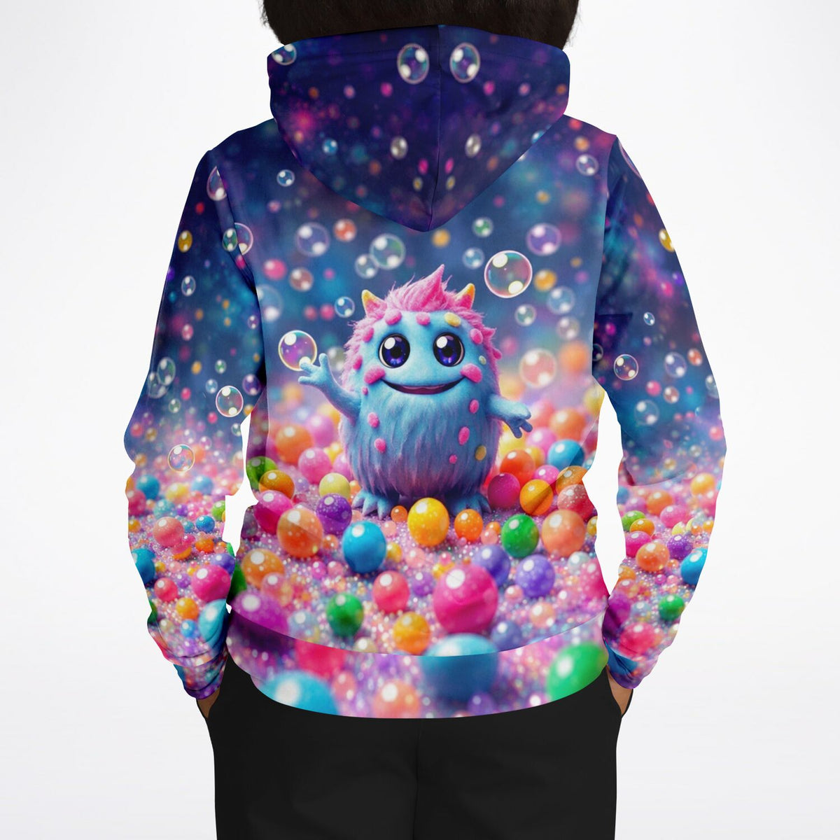 Dreamer Hoodie mit buntem Muffti-Monster-Design, umgeben von schwebenden Seifenblasen und farbenfrohen Kugeln.