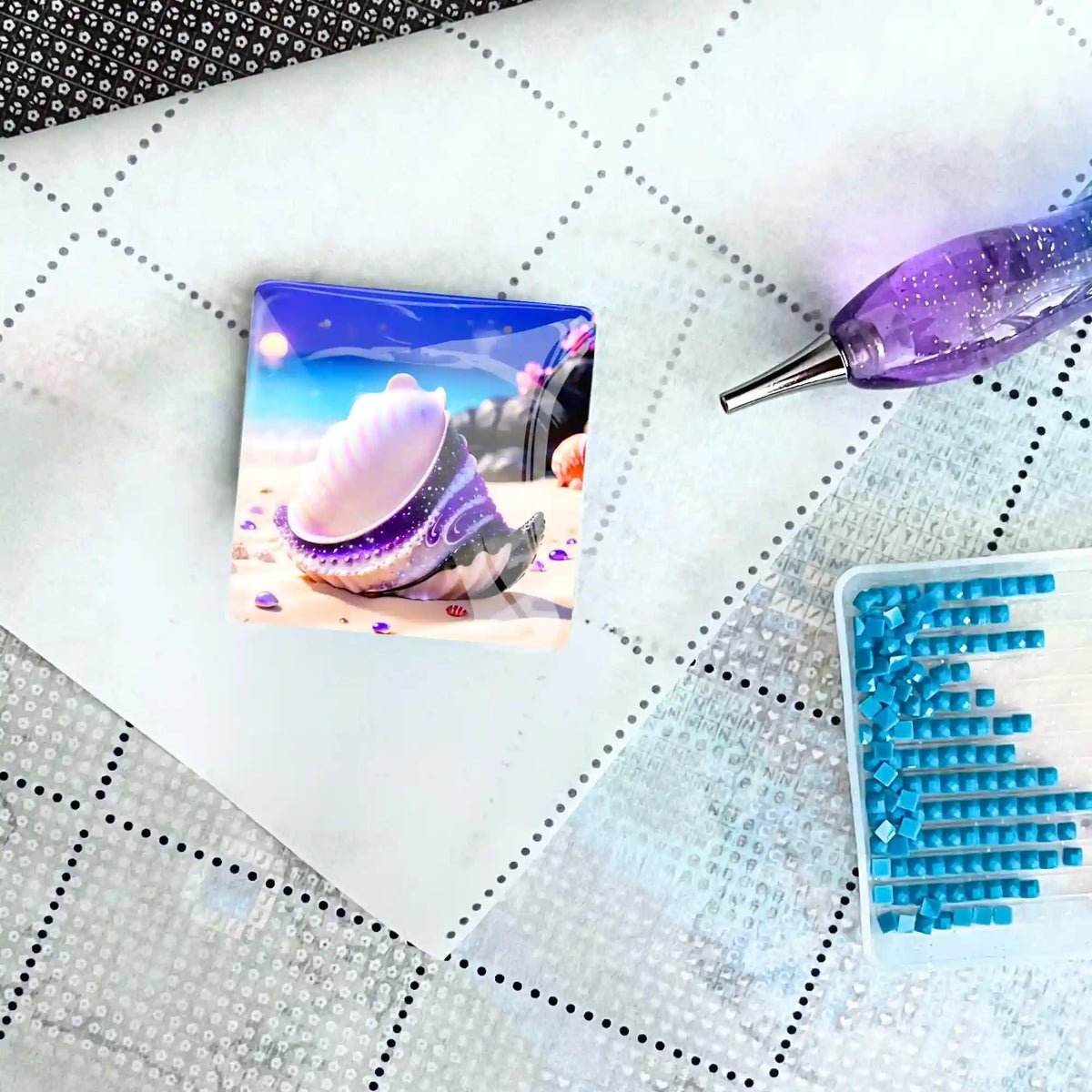 Violetter Cover Minder Muschel für Diamond Painting auf einer Leinwand mit Stift und blauen Glitzersteinen