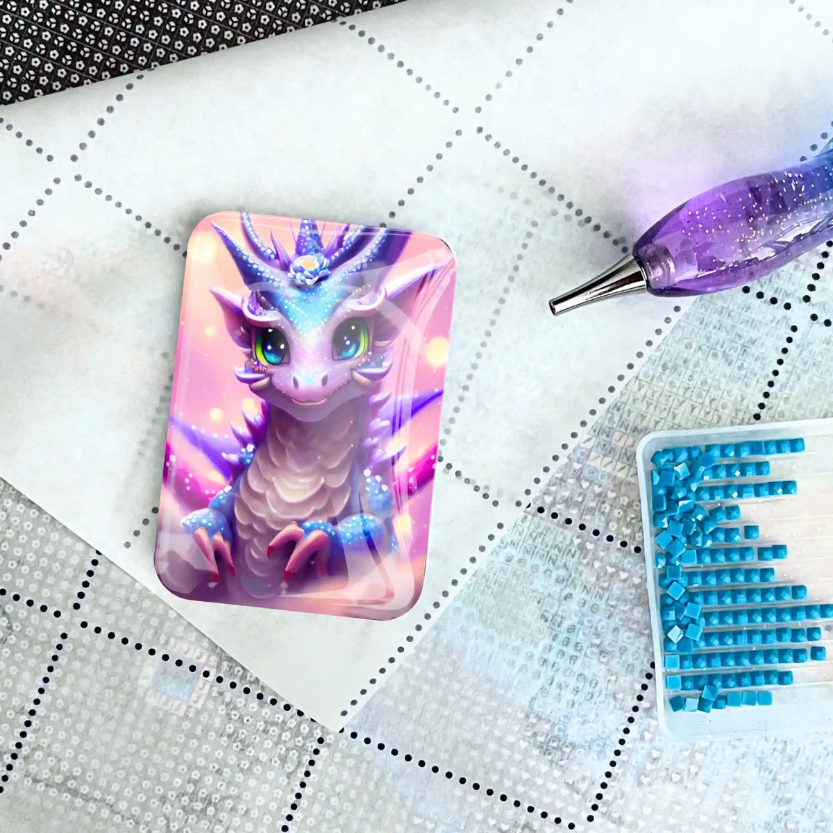 Niedlicher Drachen-Coverminder aus Glas für Diamond Painting auf einer Leinwand mit Stift und blauen Steinchen
